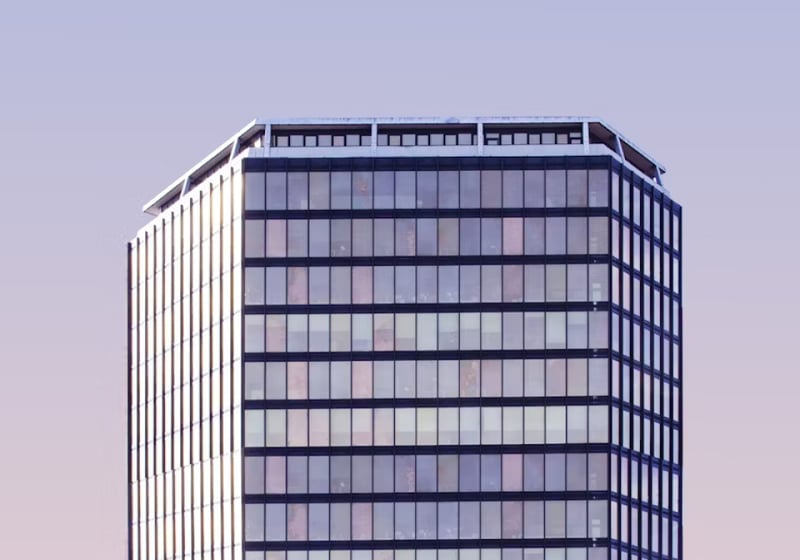 Modern office building representing our company headquarters Modern office building representing our company headquarters